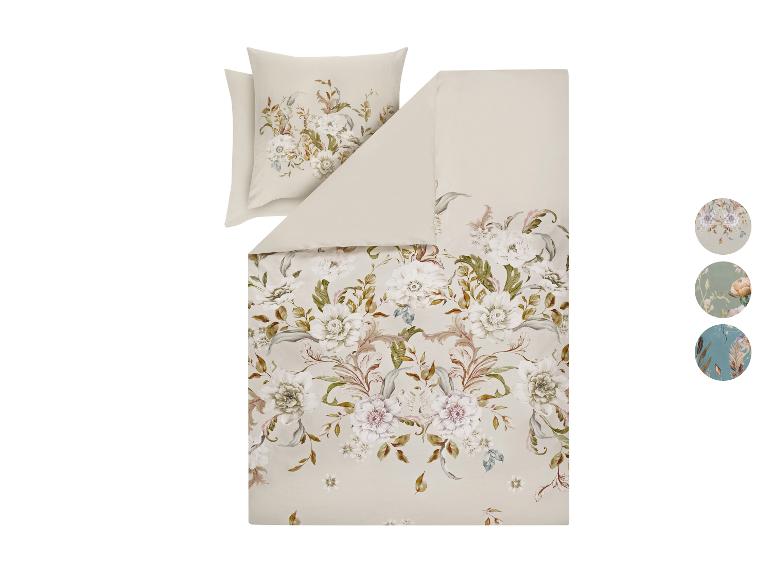 Parure de lit florale avec taies d'oreiller de couleur beige clair, ornée de fleurs blanches et roses.