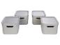Quatre paniers de rangement en plastique blanc avec couvercles.