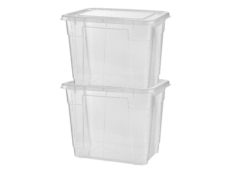 Deux boîtes de rangement en plastique transparent empilées l'une sur l'autre