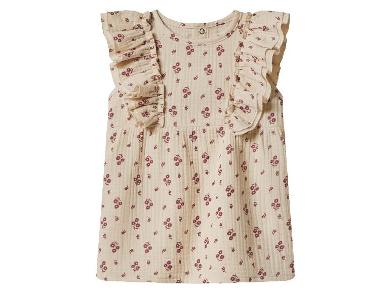 Robe bébé beige avec imprimé floral rouge et volants aux épaules.