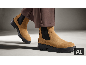 Bottines Chelsea en daim marron clair à semelles noires épaisses portées avec un pantalon marron