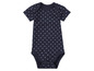 Un body bébé bleu marine à pois blancs.