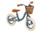 Une draisienne bleue Huffy avec un panier.