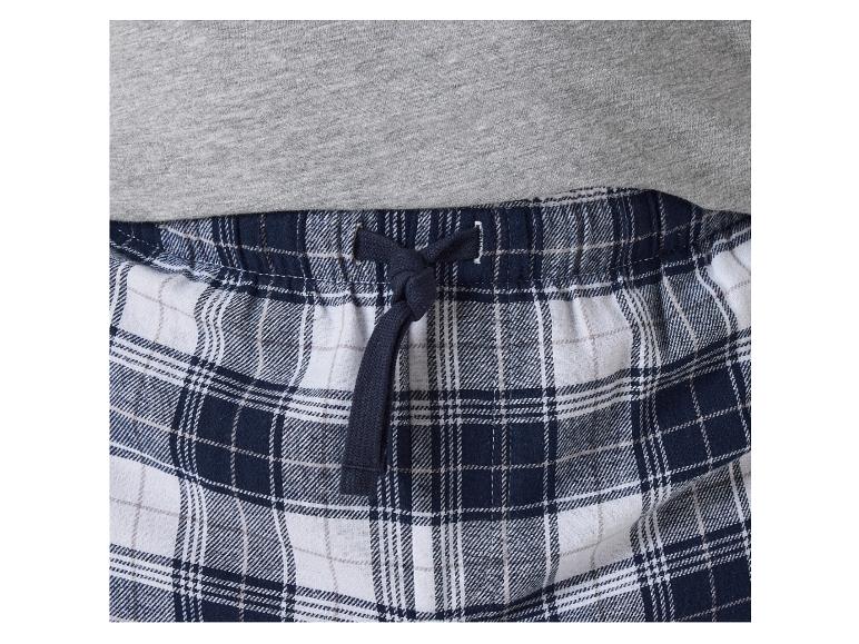 Pantalon de pyjama à carreaux bleus et blancs avec élastique et cordon.