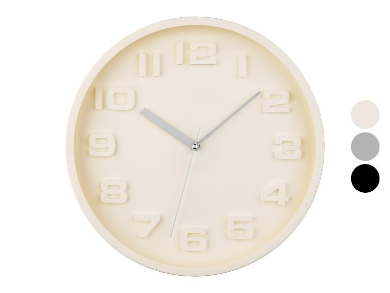 Horloge murale ronde, design minimaliste, couleur crème.