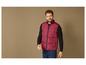 Un homme portant un gilet matelassé rouge foncé et un pull noir.