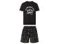 Un t-shirt noir avec le logo Power Pacific et un short à carreaux noir et blanc.