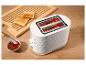 Grille-pain blanc avec du pain grillé, de la confiture et une planche à découper en bois.