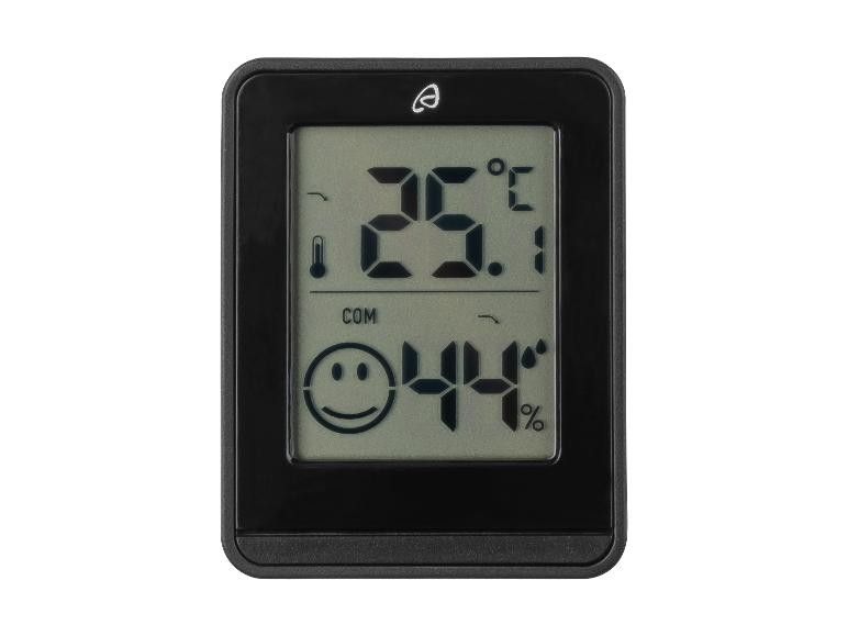 Un thermomètre et hygromètre numérique avec un sourire, affichant 23,1 degrés Celsius et 44% d'humidité.