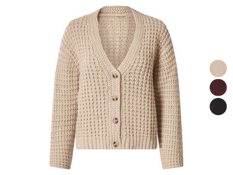 Cardigan en maille beige avec boutons et une palette de couleurs sur le côté.