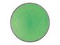 Une lampe ronde verte avec des points blancs.