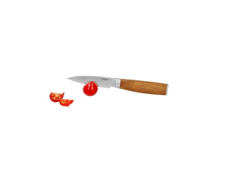 Couteau d'office avec manche en bois coupant une tomate cerise