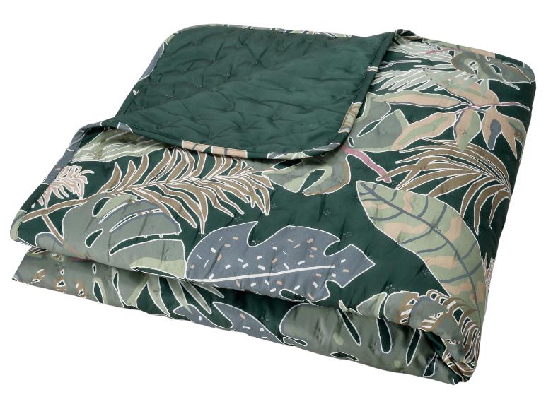 Couette pliée avec un motif de feuilles tropicales vert foncé et un revers vert foncé uni.