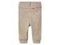 Pantalon bébé beige avec taille haute et poignets élastiques.