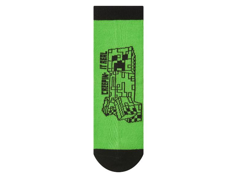 Chaussette verte avec motif de monstre pixelisé noir et texte 'CREEPIN' IT REAL'.