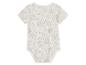 Body bébé à manches courtes, motif feuilles tropicales beige clair.