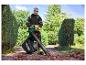 Homme utilisant l'aspirateur-souffleur de feuilles électrique PARKSIDE® PELSB 3000 B2 dans le jardin.
