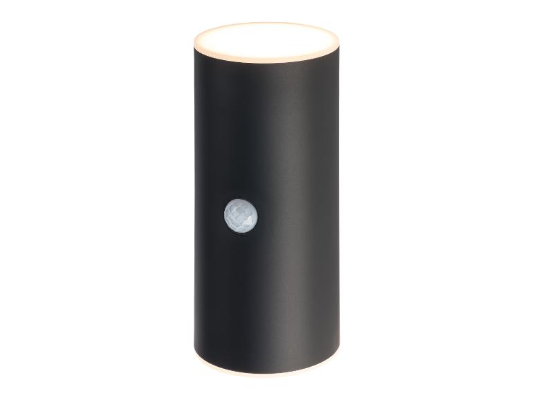Un applique murale cylindrique noir pour extérieur avec capteur de mouvement intégré.