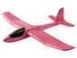 Un avion en mousse rose avec des points bleus.