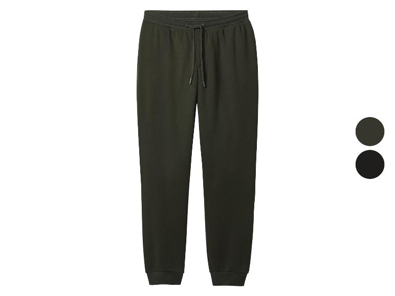 Pantalon de jogging vert foncé avec cordon de serrage et poignets élastiques.