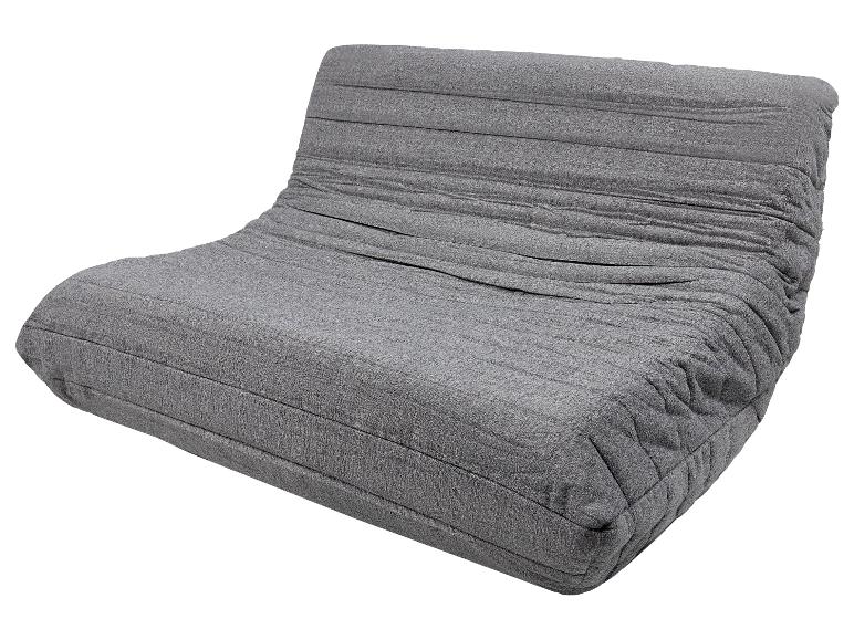 Fauteuil de sol gris avec dossier et revêtement textile plissé.