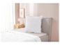 Couette et oreiller blancs sur un lit moderne.