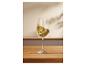 Une coupe de vin blanc sur une table en bois.