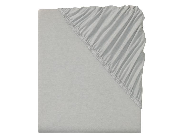 Un drap housse gris avec élastique.
