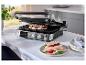 Grill avec deux sandwichs, tomates, mozzarella et basilic, sur une table blanche.