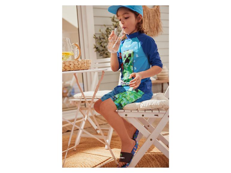 Enfant portant un maillot de bain et des claquettes Minecraft.
