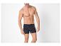 Homme en caleçon boxer bleu foncé avec motif d'ancres blanches.