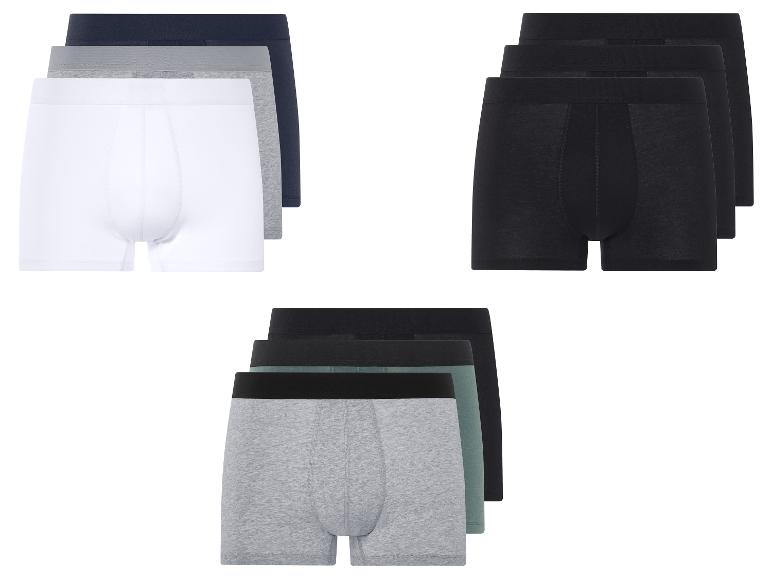 Trois paires de boxers en noir, gris, blanc et vert.