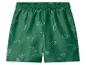 Short de bain vert avec motif dinosaure blanc pour enfants.