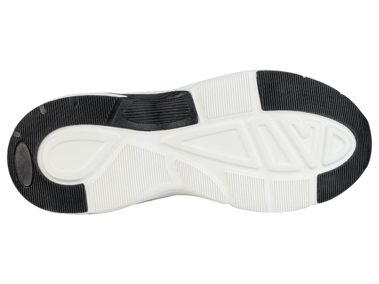 La semelle d'une basket blanche avec un motif noir.