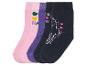 Trois paires de chaussettes avec un motif licorne, des cœurs et des formes géométriques.