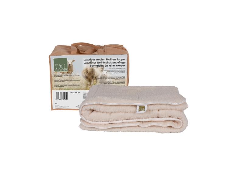 Un surmatelas en laine TXL luxueux et son emballage.