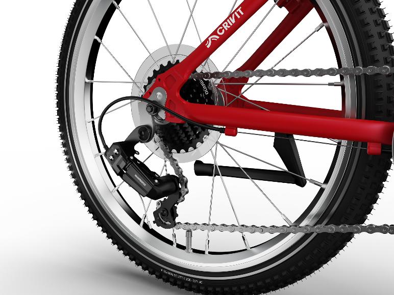 Gros plan de la roue arrière d'un vélo rouge, montrant le dérailleur, la cassette et la chaîne.