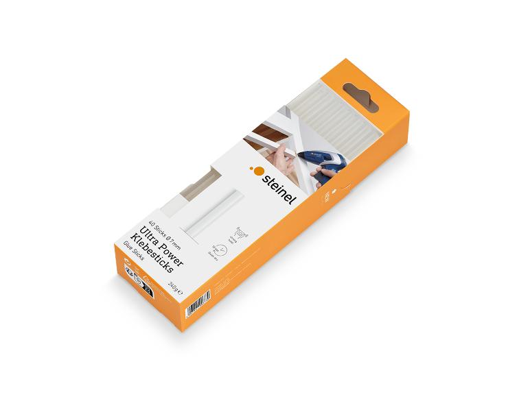 Emballage de bâtons de colle orange avec un pistolet à colle chaude.