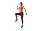 Femme en vêtements de sport sautant.