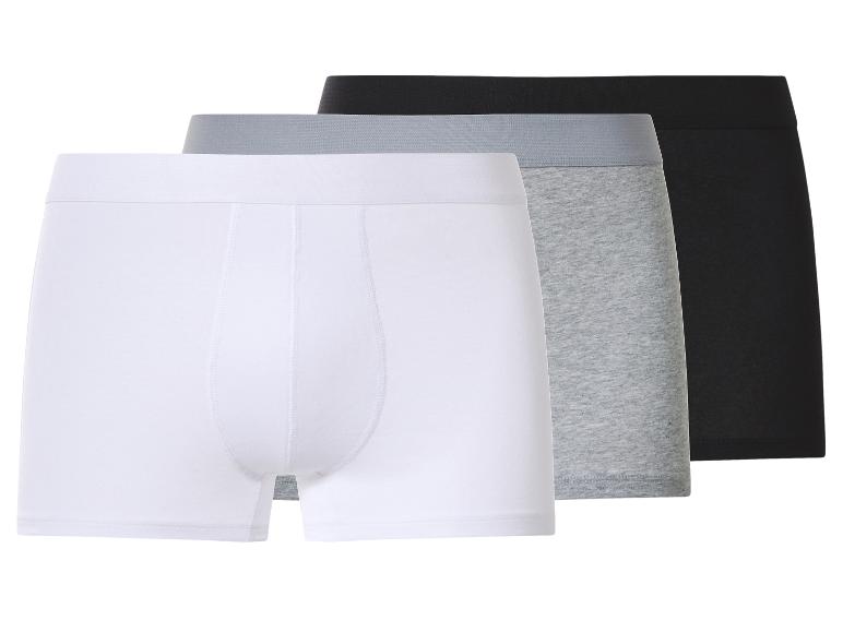Trois boxers pour hommes en blanc, gris et noir.