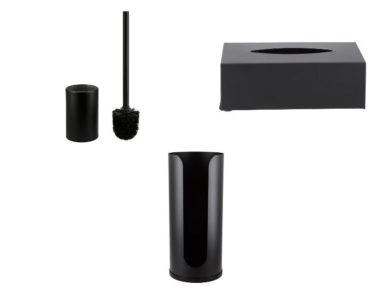Accessoires de salle de bain noirs : brosse WC, boîte à mouchoirs et porte-rouleau de papier toilette.