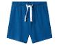 Shorts bleus en coton pour enfants avec cordon de serrage blanc à la taille élastique.
