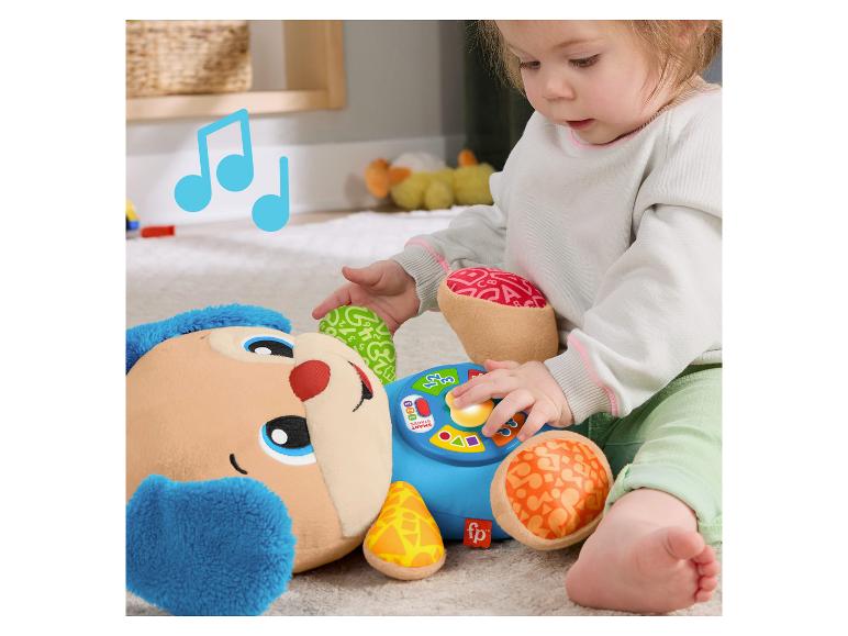 Un tout-petit joue avec le chien interactif Fisher-Price Lernspaß Hündchen.