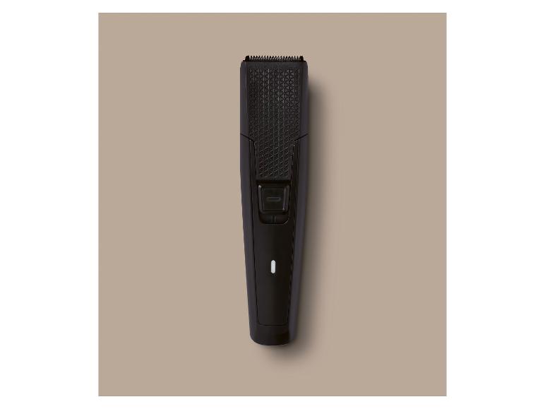 Tondeuse à barbe noire avec un motif géométrique et un bouton marche/arrêt.