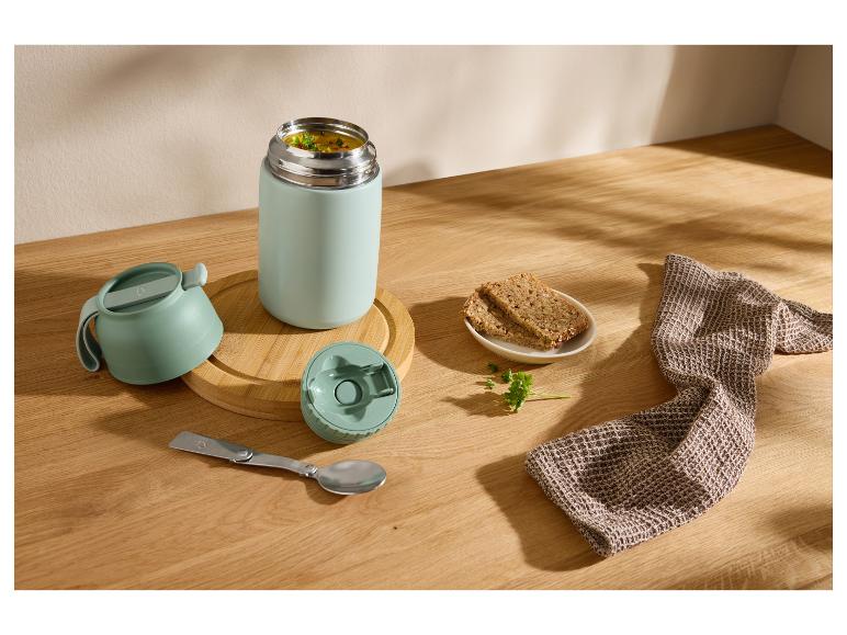 Bouteille isotherme avec soupe, pain et cuillère pliable sur une table en bois.