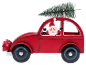 Décoration de Noël: voiture rouge avec le Père Noël et un sapin de Noël sur le toit.