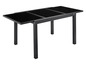 Une table à manger noire avec un plateau en verre et des pieds en métal noir.