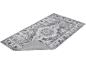 Tapis gris avec motif floral et médaillon central, avec le dos antidérapant visible.