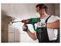 Un homme utilise un marteau perforateur Parkside pour casser des carreaux.