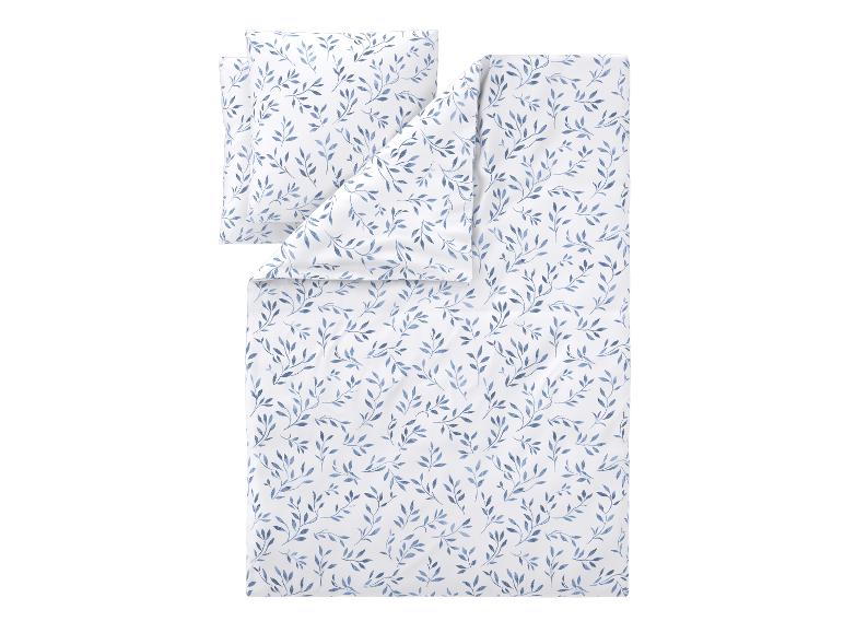 Parure de lit blanche avec housse de couette et taie d'oreiller à motif de feuilles bleues.